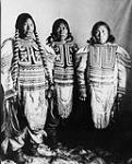 Three Inuit women wearing beaded parkas in front of a canvas backdrop, Fullerton, Nunavut [Left to right: Hattie (Niviaqsarjuk), Suzie and Jennie] 1904.
