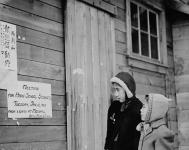 Japanese-Canadian girls reading signs outside the school at the Japanese-Caninternment camp. ca. 1943