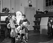 Santa visiting Black community centre. Dec. 19, 1950