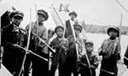 Caribou Lake [Ont.] Indian Boys with their bows and arrows with which they can shoot very acurately 1930