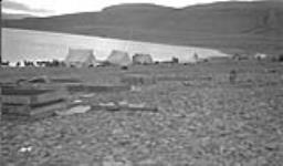 [Inuit tents near shoreline] Original title: Native tents. 11 September 1936.