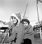 Mrs. Martin Malti and her child in the Pictou shipyard  Jan. 1943