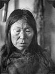 [Elderly Inuk woman with her hair down]. Original title: Old native woman Eskimo, heavily tattooed but does not photograph  1929.