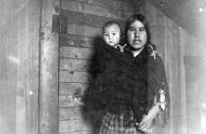 Inuk nursemaid with the child of a Hudson's Bay Company agent. 1926