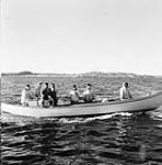 A whale boat carrying a group of Inuit men at Chesterfield Inlet (Igluligaarjuk) 1948