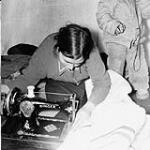 Inuk woman using a Singer Sewing machine. 1948