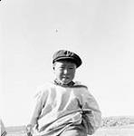 Inuk boy in a newsboy cap and duffle parka. 1948
