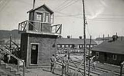 [Prisoners of war walking inside wired fences of Red Rock Internment Camp, Ontario (Camp R)]. [ca. 1940-1941].