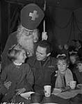 [Father Christmas and children at a Christmas party]. 0000