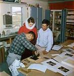[Barbara Hinds with printmakers Lukta Qiatsuk and Iyola Kingwatsiuk]  [between August 24-October 3, 1960].