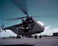 HO4S-3 Sikorsky Horse Helicopter showing how it can hoist a rescue stretcher. 1957