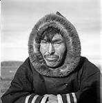 [Artist Kiakshuk wearing a hooded coat, Kinngait, Nunavut]. [between 1956-1960]