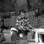 [Inuksiak making a fishing net, Iqaluit, Nunavut]. [between 1956-1960]