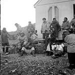 [Group gathered near the entrance to an Anglican Church, Kinngait, Nunavut]. [between 1956-1960]