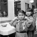 [Group of Brownies getting ready near a bathroom sink, Iqaluit, Nunavut]. 1960