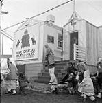 [Group of women and children outside the Royal Canadian Mounted Police building, Iqaluit, Nunavut]. 1960
