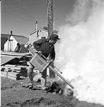 [Man spraying anti-mosquito spray, Niaqunngut, Iqaluit, Nunavut]. 1960