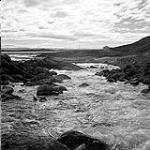 [Stream flowing into a larger body of water, Iqaluit, Nunavut]. 1960