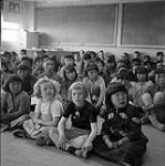 [Children sitting on the ground in a classroom, Iqaluit, Nunavut]. 1960