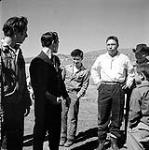 [Men and boys standing outside, Niaqunngut, Iqaluit, Nunavut]. 1960