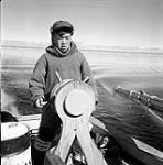 [Mosha Michael steering a boat, Iqaluit, Nunavut]  1960