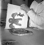 [Lukta Qiatsuk making a print, Kinngait, Nunavut]. 1960
