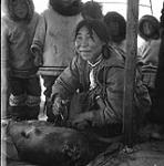 [Sheouak Petaulassie using an ulu, Kinngait, Nunavut]. 1960