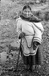 [Woman standing outside with cane, Kinngait, Nunavut]. 1960