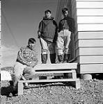 [Artists Eegyvudluk Pootoogook, Iyola Kingwatsiak, and Lukta Qiatsuk outside the Cape Dorset Craft Centre, Kinngait, Nunavut]. 1960