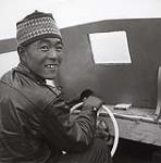 [Willy Eetok steering a boat, Killiniq, Nunavut]. 1960