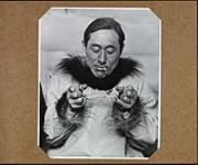 [Young Inuk man playing an Inuit string game] Original title: The Eskimos are famous for their intricate string games. This young man, in spite of store shirt and goldseal ring, has not forgotten the lore of his people. 1949