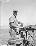 LAC John Jeremy, Busby, Alberta, cleans Dakota spark plugs 28 February 1945.