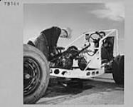 John Rottluff works on motor of race car at B.C. Custom Car Association, Abbotsford, B.C. June 1955