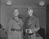C.G.S. presenting trophy to Cadet young husband 28 August 1959.