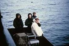 Mrs. Swail, Dr. Cowhert(?) and technicians on boat during an x-ray survey, Repulse Bay. 1953