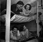 Helen Salkeld, Audrey James, Anna Brown and another woman on bunk beds  August-September, 1954.