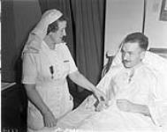 Flying Officer Wally Prosser in his hospital bed in Calcutta. 27 June 1944.