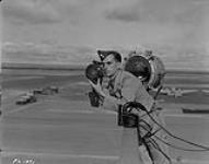 Leading Aircraftman C.F.K Mews sending a message with an Aldis lamp. Camp Borden  July 30, 1940.