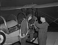 Flight instructor R.W. McRae assists a student at No. 8 Elementary Flying Training School in Vancouver, British Columbia  September 27, 1940