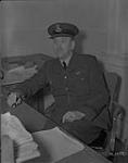 Portrait of Flight Lieutenant C.A. Davidson seated at a desk at No. 4 Air Training Command, Regina, Saskatchewan  October 4, 1940