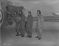 Pilots G.M. Auld, S.W. Shapton, H.B. Hallet and E.A. Hayes climb into an Avro Anson aircraft at No. 4 Service Flying Training School, Saskatoon, Saskatchewan  October 4, 1940