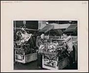 Russ Ducharme (left) and Danny Bannon working at Chrysler Corporation's engine plant in Windsor, Ontario [between 1930-1960]