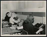 [Three women working at short-hand machines, Regina, Saskatchewan, 1950s]. ca. 1950