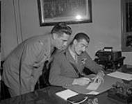 Major General J.D.B. Smith and Private Joe Fleming sign up for Community Chest Drive. Ottawa, Ontario. 26 September 1958.