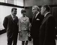 Nancy Greene outlining her views on various aspects of amateur sport in Canada to Minister of National Health and Welfare, the Hon. John Munro (left), Dr. J.W. Willard, Deputy Minister of National Health and Welfare (centre) and L. Lefaivre, Fitness and Amateur Sport Directorate (right) 1968