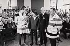 Nancy Greene and the Hon. J.R. Nicholson, Minister of Labour, with two members of the Canadian ski team at Nancy Greene's gold medal presentation, 1968 Winter Olympics. February 1968