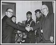 [Walpole Island and Parry Island juvenile hockey players playing in a tournament, men and some of the boys are shaking hands]. 1967