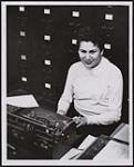 Miss Lorna Kirkness of Fisher River works at her desk in the Tuberculosis Registry of the Manitoba Sanitorium board, Bannatyne avenue. [ca. 1958]