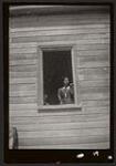 [Woman standing in a window]. [between 1900-1950]