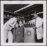 [A man instructing two younger men on Sun Service Equipment]. [between 1900-1976]